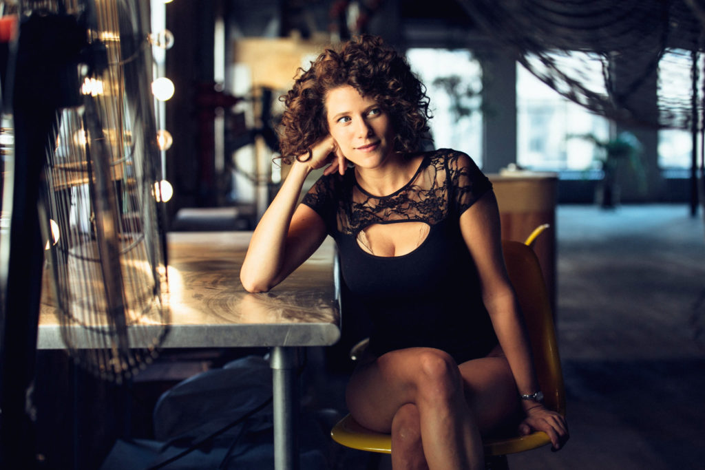 Cyrille Aimée sitting at a table