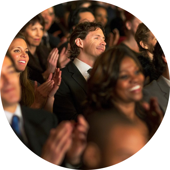An image of people cheering in a theater