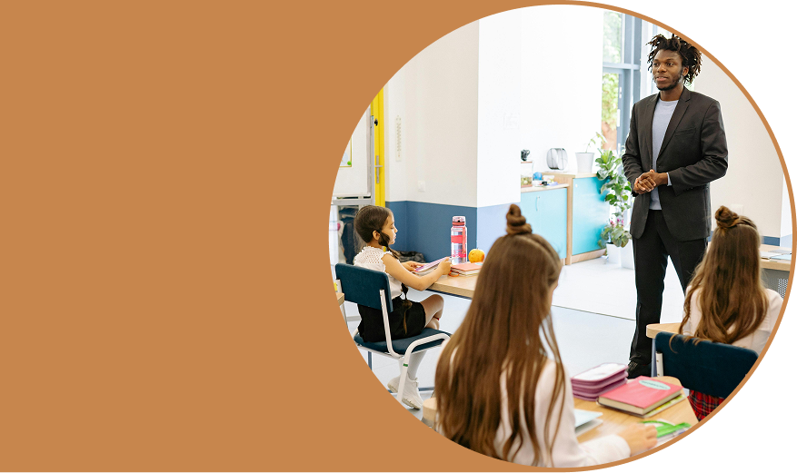 An image of a teacher in front of a classroom
