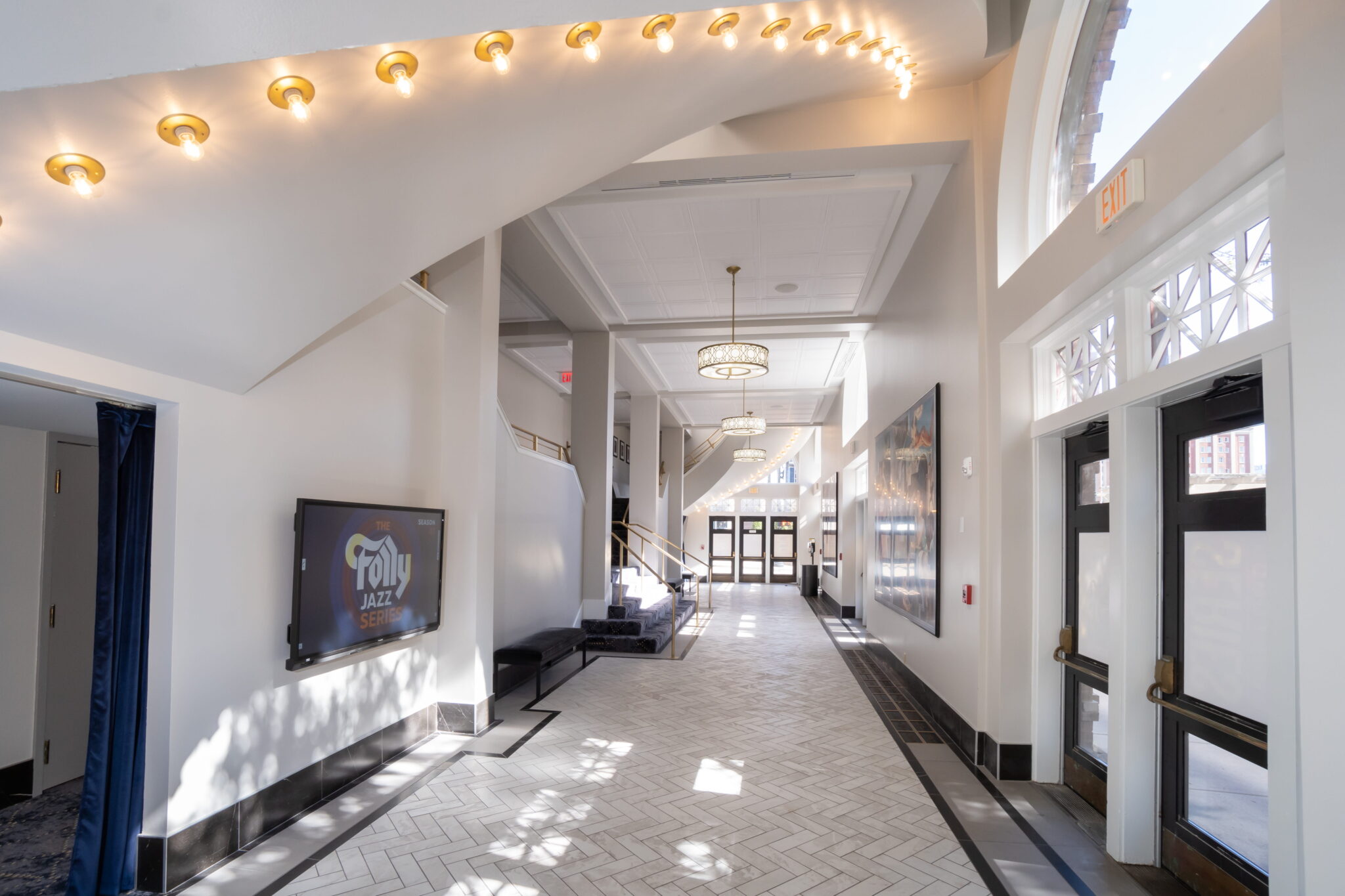 Hallway inside of the folly with white walls and light string