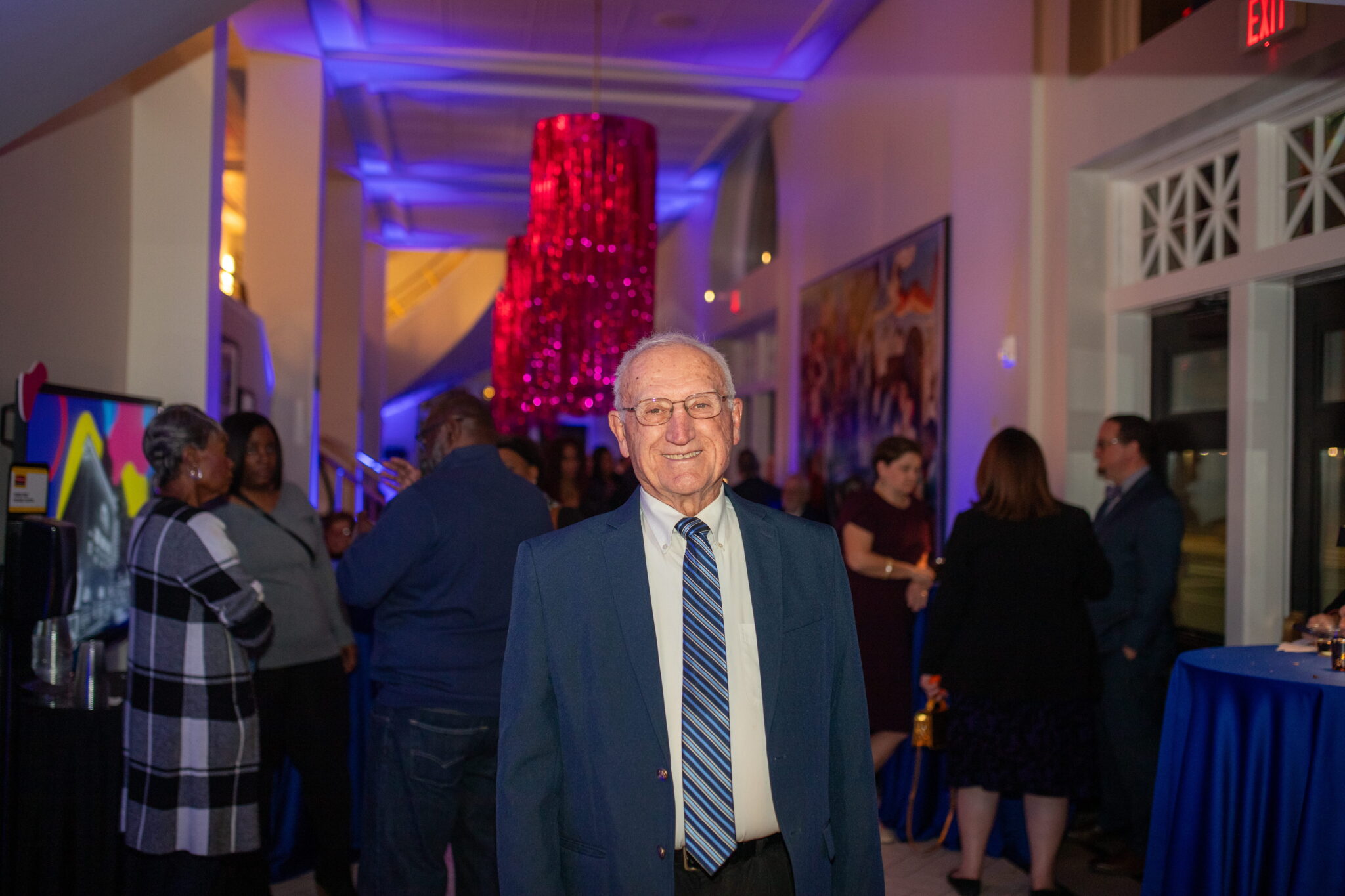 Man standing and smiling in a hallway
